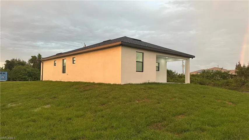 View of property exterior featuring a yard