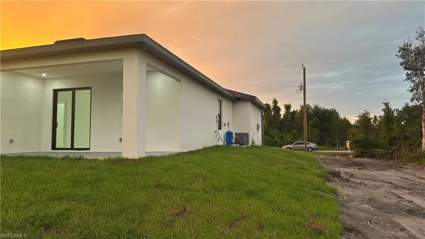 Property exterior at dusk with a lawn
