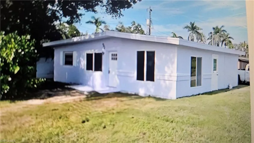 Back of property with a yard