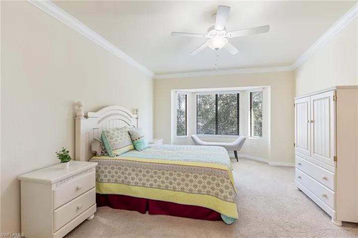 Nicely furnished primary bedroom with Queen bedroom set, 2 end tables and armoire.