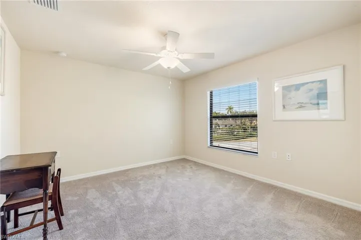 Second Bedroom with carpet, fan/light fixture.