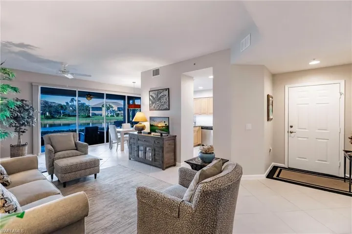 Living room with ceiling fan and light tile patterned floors