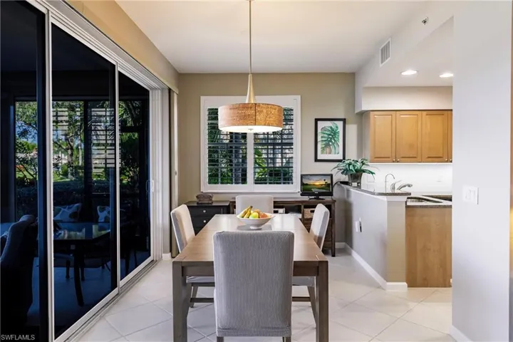 Dining room featuring plenty of natural light, light tile patterned floors, and sink