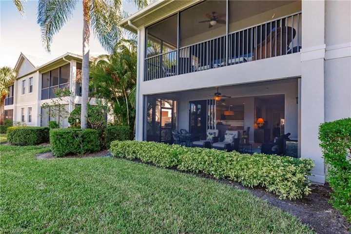 Rear view of property with a lawn, outdoor lounge area, and ceiling fan