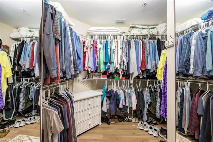 Spacious closet featuring light hardwood / wood-style floors