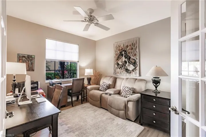 Living room featuring light wood-type flooring, plenty of natural light, and ceiling fan