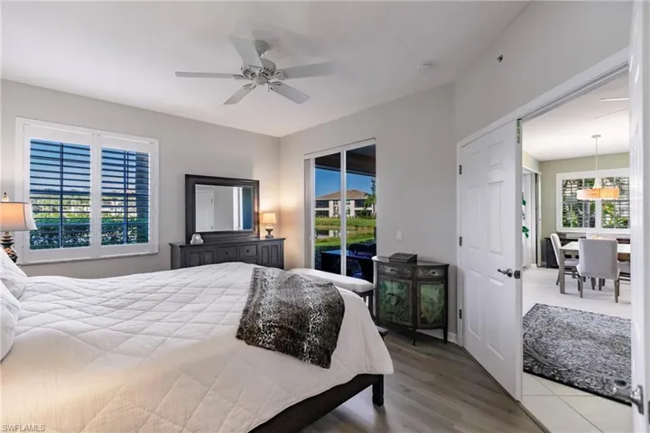 Bedroom with access to outside, ceiling fan, and wood-type flooring