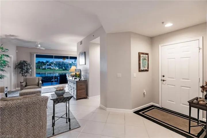 Foyer featuring ceiling fan and light tile patterned floors
