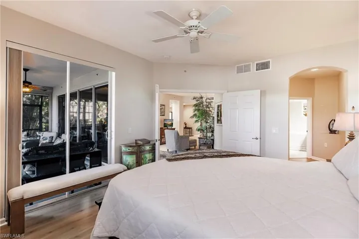 Bedroom with access to exterior, wood-type flooring, and ceiling fan