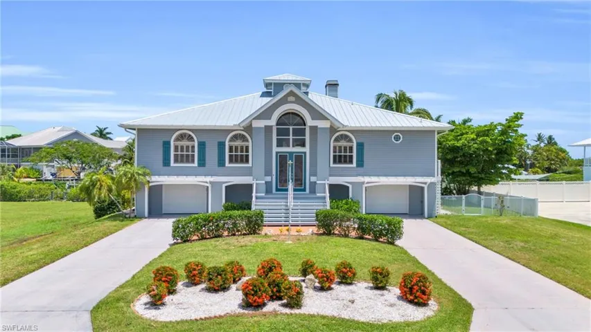Raised ranch with a garage and a front yard