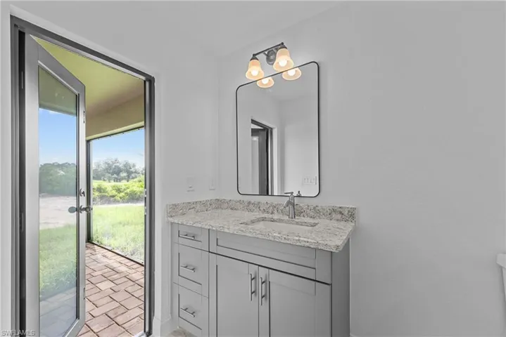 2nd Master Quarters bathroom leading to screened lanai