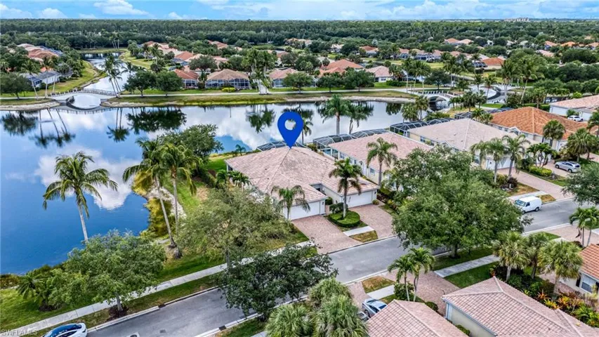 Aerial view of residential area featuring a nearby body of water