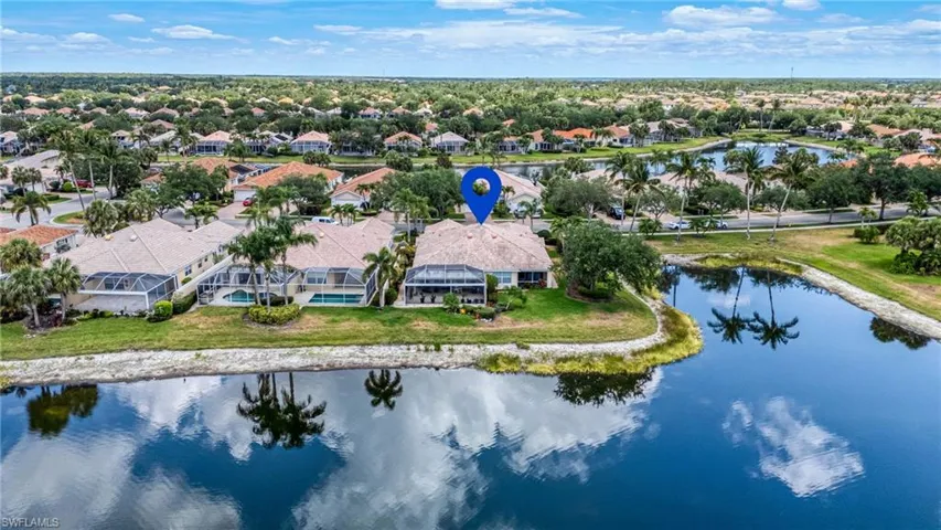 Aerial view of residential area featuring a nearby body of water