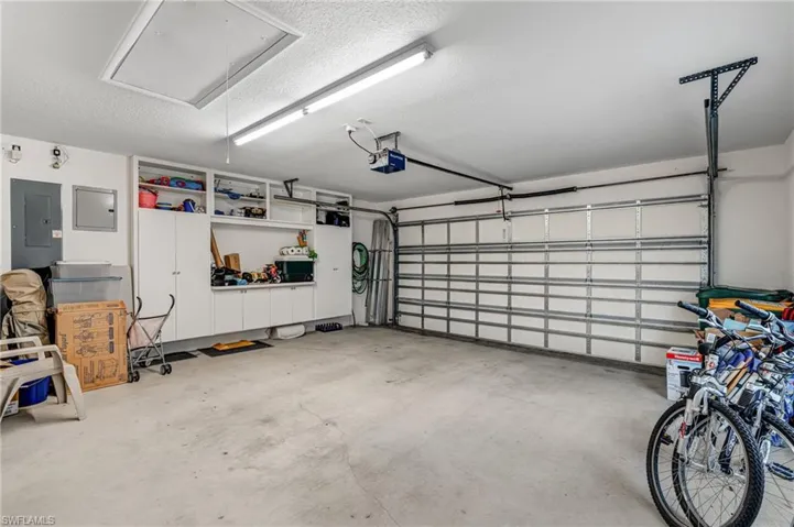 Garage with a garage door opener and electric panel