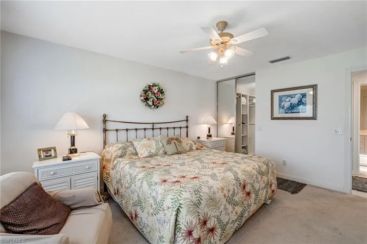 Bedroom featuring carpet floors, a closet, a ceiling fan, and baseboards