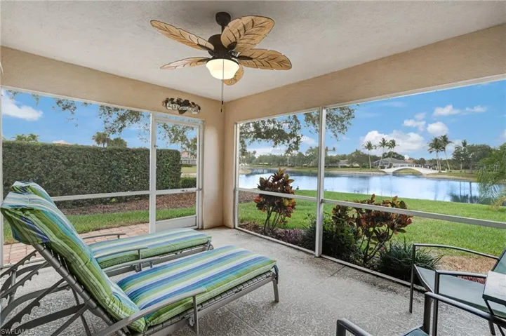 Sunroom / solarium featuring a water view and a ceiling fan