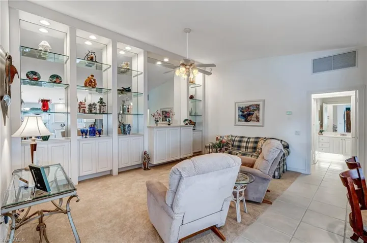 Living room featuring a ceiling fan, recessed lighting, and light tile patterned flooring