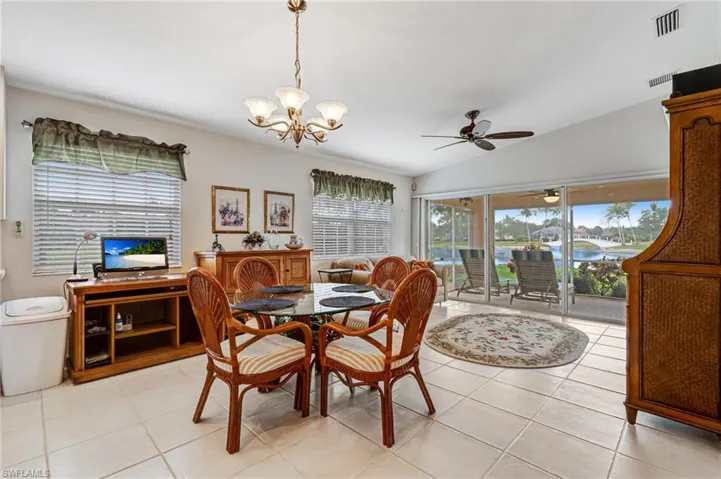 Dining area featuring plenty of natural light, ceiling fan, vaulted ceiling, and a chandelier