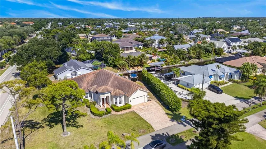 Single-story residence featuring a tile roof, an integrated two-car garage, and a paver driveway
