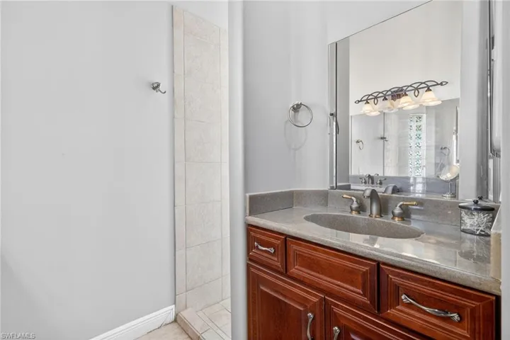 Vanity with a stone countertop and an undermount sink