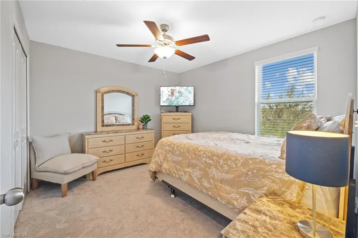 Bedroom featuring carpet flooring, a closet, and ceiling fan