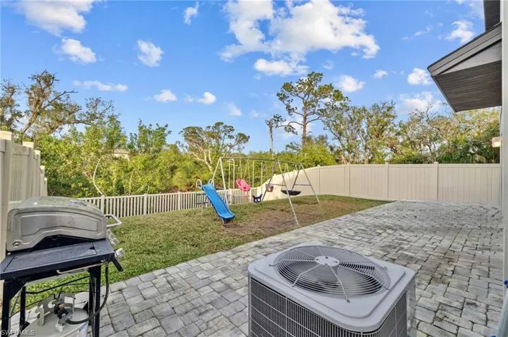 View of patio featuring a playground, central AC, and grilling area
