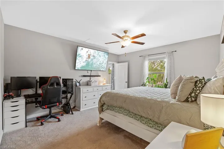 Carpeted bedroom with ceiling fan