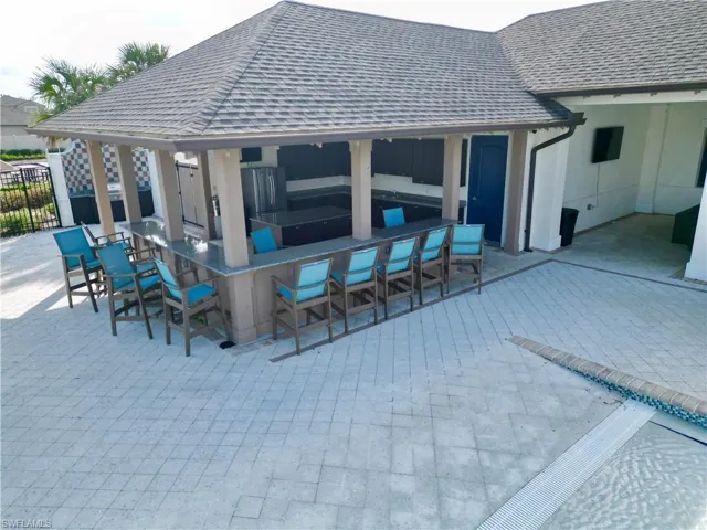 View of patio with a bar