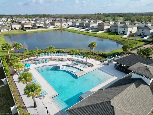 Birds eye view of property with a water view