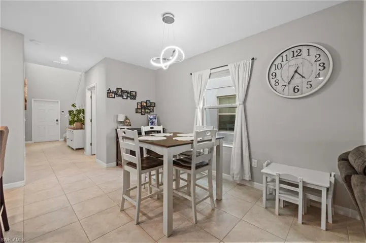 Dining room featuring light tile patterned floors and a chandelier