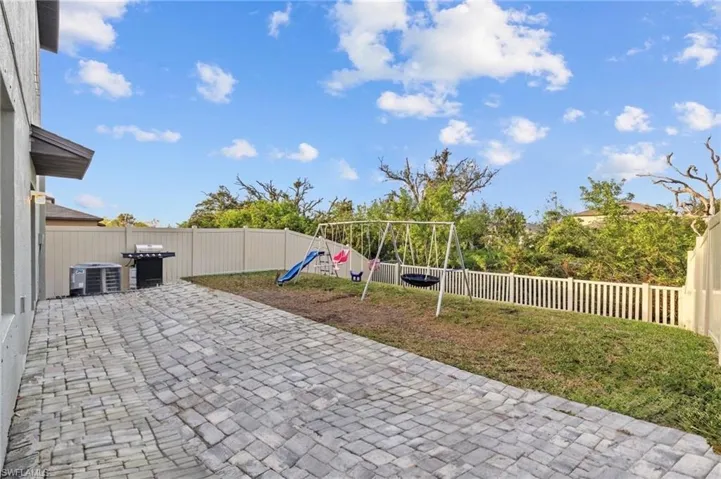 View of patio with a playground - AI Modified for a full view of patio