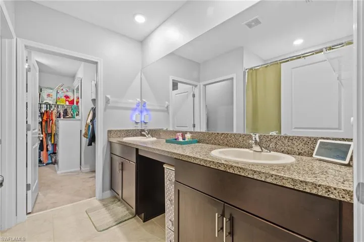 Bathroom with tile patterned floors and vanity