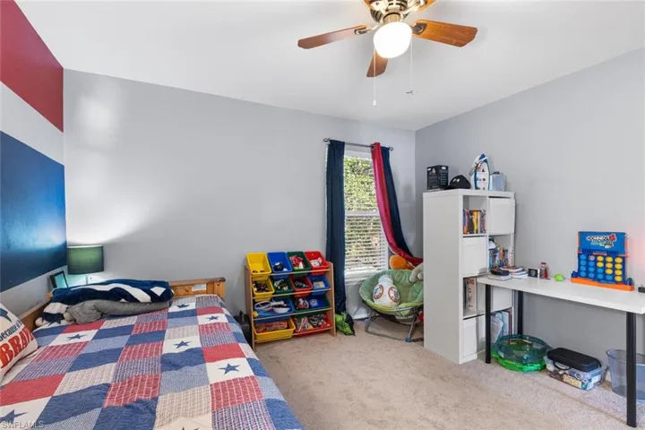 Carpeted bedroom with ceiling fan