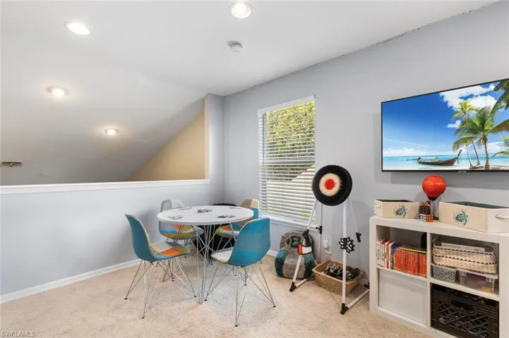 Recreation room with carpet, recessed lighting, and lofted ceiling