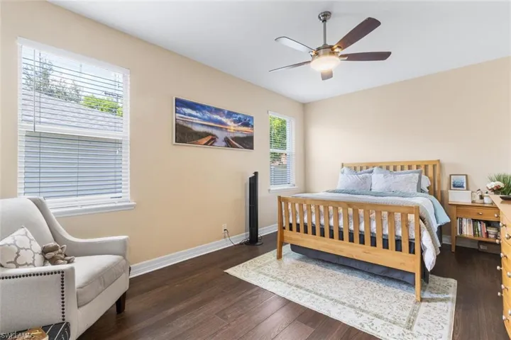 Bedroom featuring dark wood-style flooring and ceiling fan