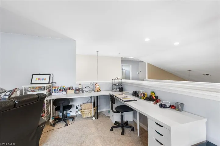 Office with lofted ceiling, carpet floors, and recessed lighting