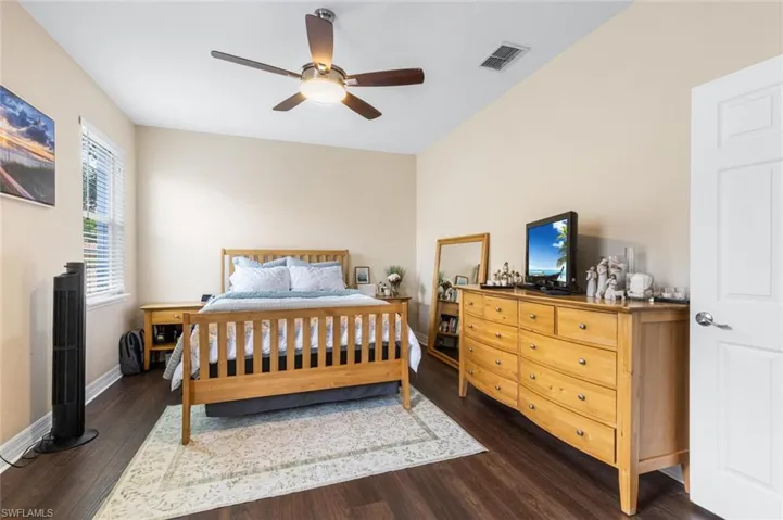 Bedroom featuring dark wood-style floors and a ceiling fan