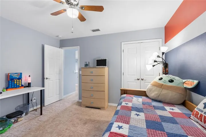 Bedroom featuring carpet floors, a closet, and ceiling fan