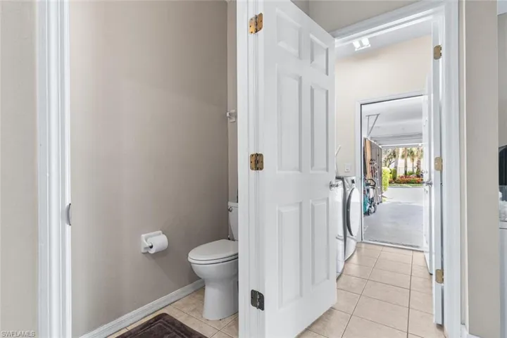 Bathroom with tile patterned flooring and separate washer and dryer