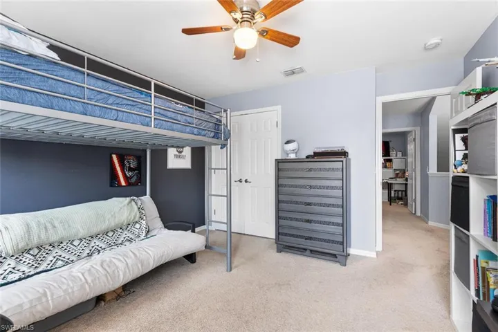 Bedroom featuring carpet flooring, a closet, and ceiling fan