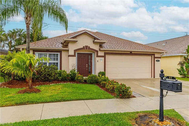 View of front of property with a garage and a front yard