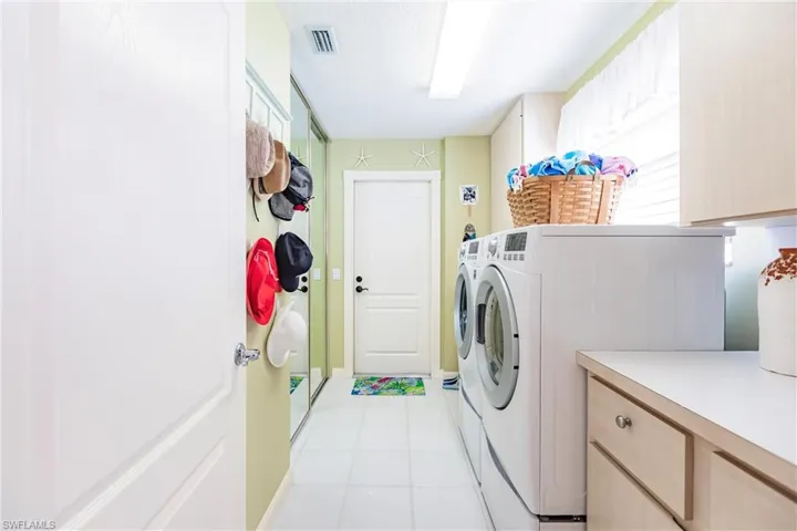 Laundry room has wonderful extra storage and a closet too.