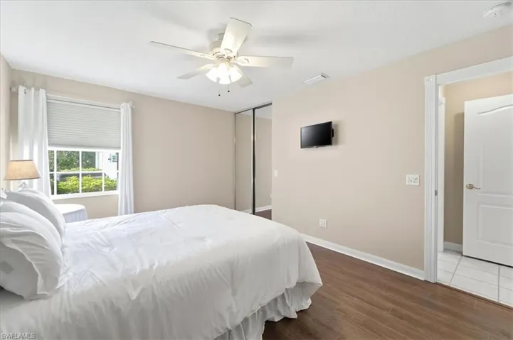 Bedroom with dark wood finished floors and ceiling fan