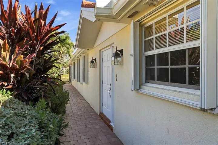 View of exterior entry featuring stucco siding
