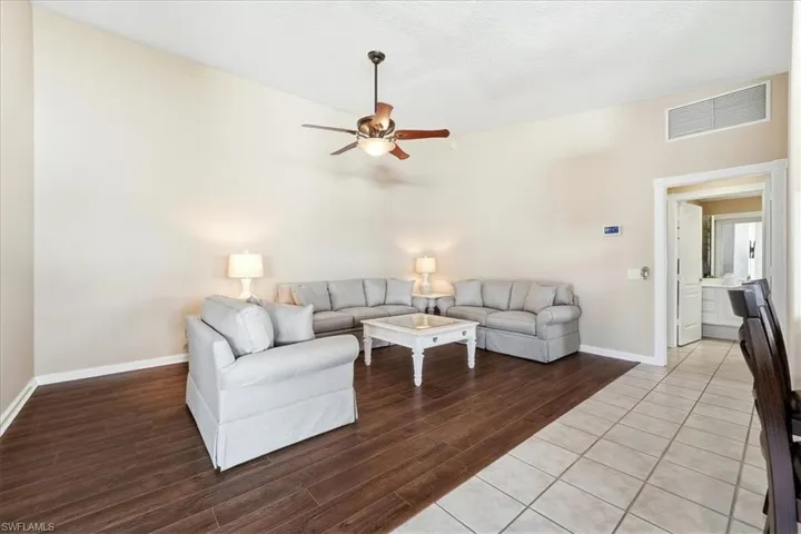 Living area with wood finished floors and a ceiling fan