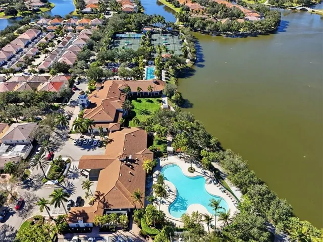 Aerial overview of property's location with a pool and a nearby body of water