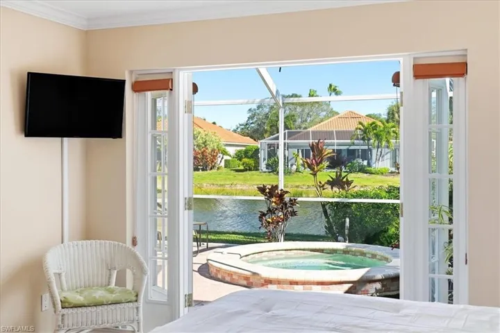 Bedroom with crown molding and access to outside