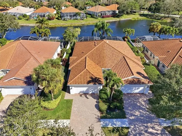 Aerial view of residential area featuring a nearby body of water