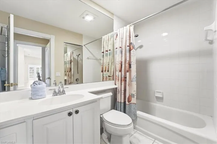 Bathroom featuring shower / bath combo and vanity