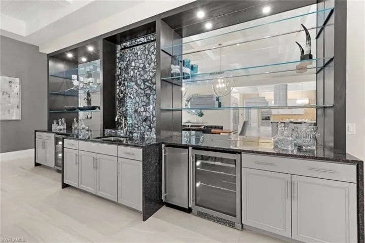 Dining area cabinetry with water feature on wall
